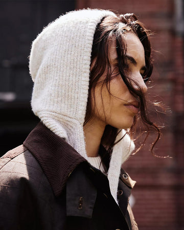 model wearing oatmeal knit bonnet with tie straps