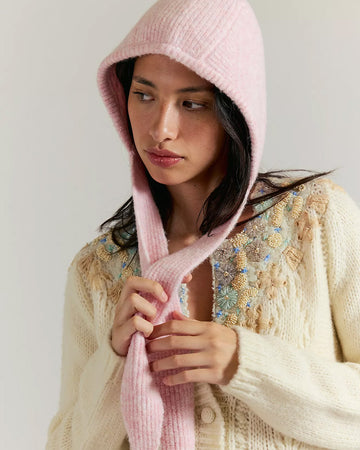 model wearing light pink knit bonnet with tie straps