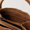 inside of cognac suede small handbag with piped handles
