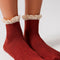 model wearing rust red crew socks with cream lace tops