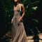 model wearing brown and white stripe maxi dress with deep v neckline and cream tie straps