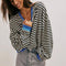 model wearing black and white horizontal stripe crewneck sweatshirt with royal blue trim