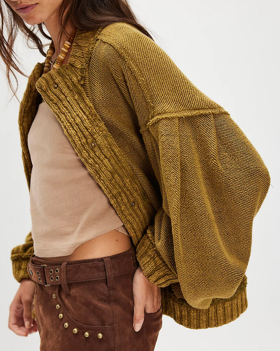 side view of model wearing slouchy olive green textured open front cardigan