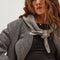 model wearing grey knit triangle essential scarf