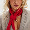 model wearing red knit triangle essential scarf