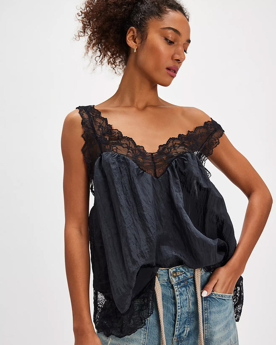 model wearing black silky tank with black lace trim on the bust, straps and hem