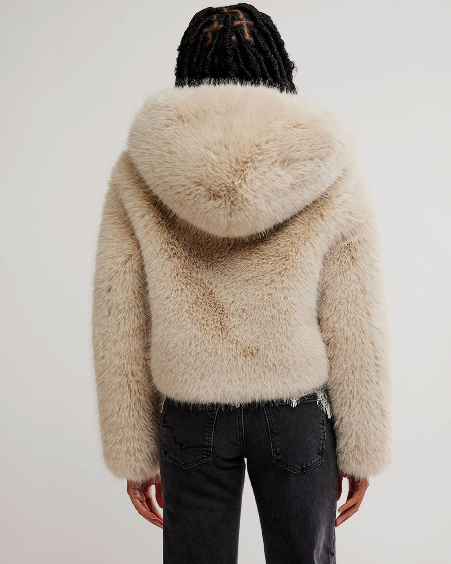 back view of model wearing ivory cropped faux fur jacket with hood