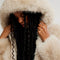 up close of model wearing ivory cropped faux fur jacket with hood