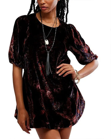 model wearing black velvet tunic with red and burgundy floral print and short sleeve puff sleeves