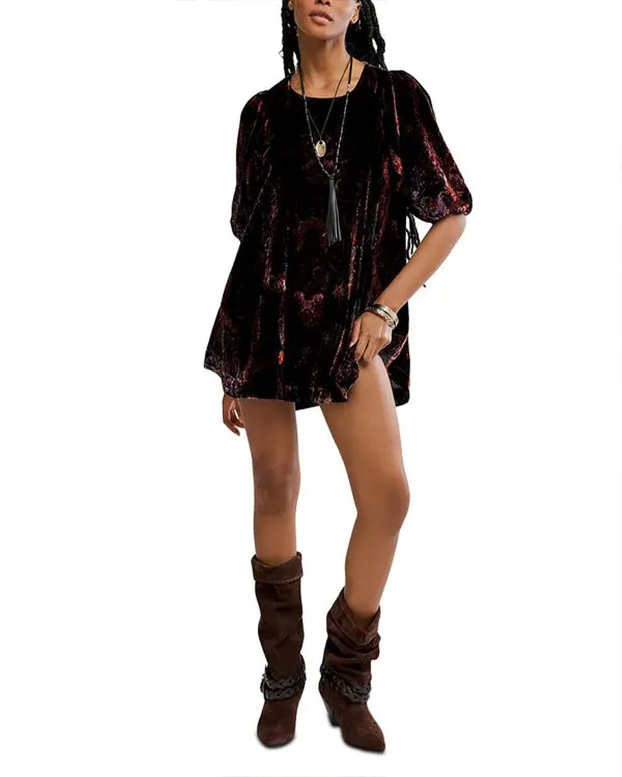 model wearing black velvet tunic with red and burgundy floral print and short sleeve puff sleeves