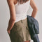 back cargo patch pockets of olive green mini skirt with pleated front and raw hem