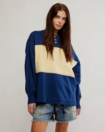 model wearing royal blue and yellow large stripe henley top