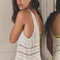 back view of model wearing white sheer maxi slip dress with lace and ruffle details