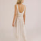 backview of model wearing white sheer maxi slip dress with lace and ruffle details