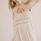 model wearing white sheer maxi slip dress with lace and ruffle details