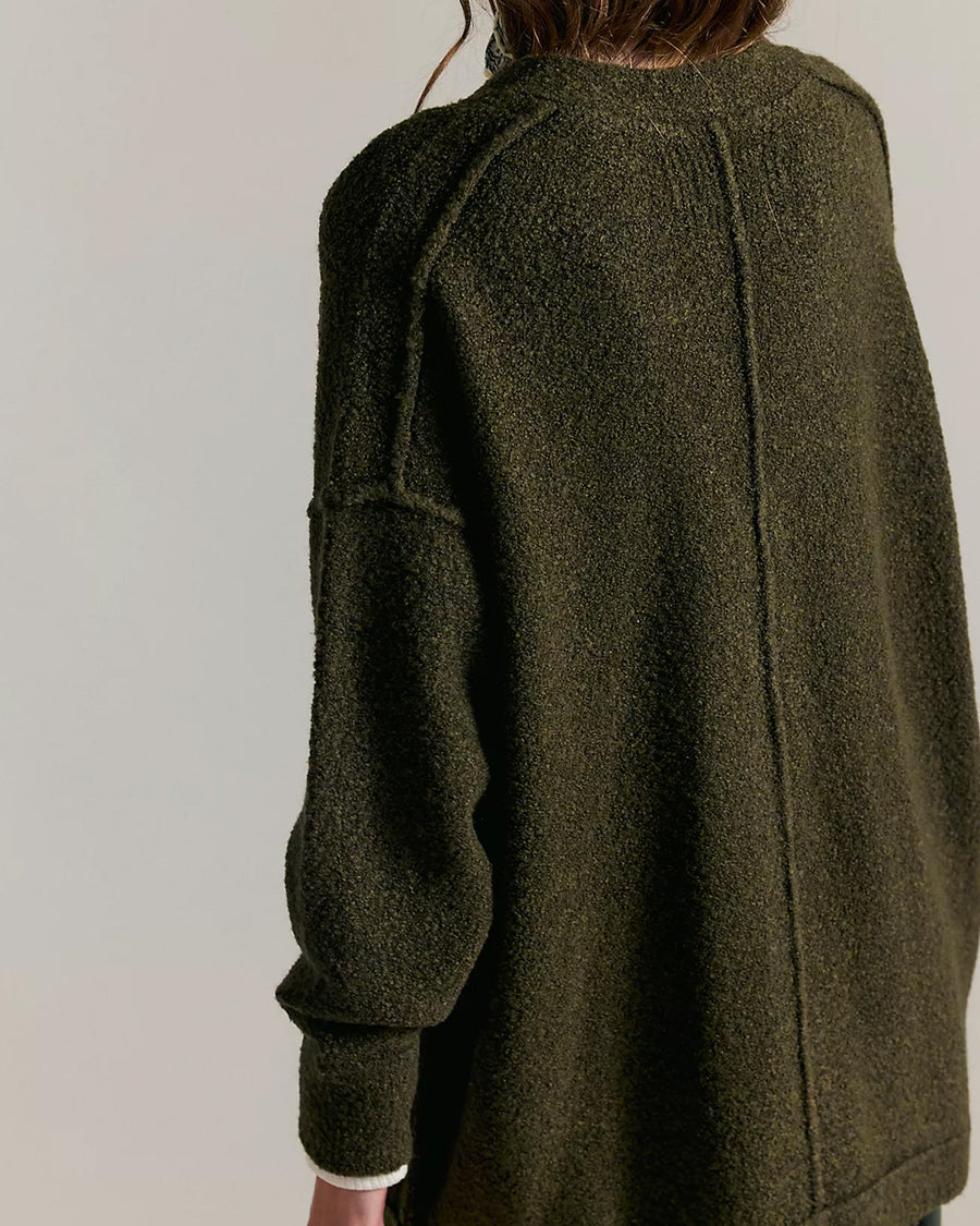 back view of model wearing oversized green textured cardigan