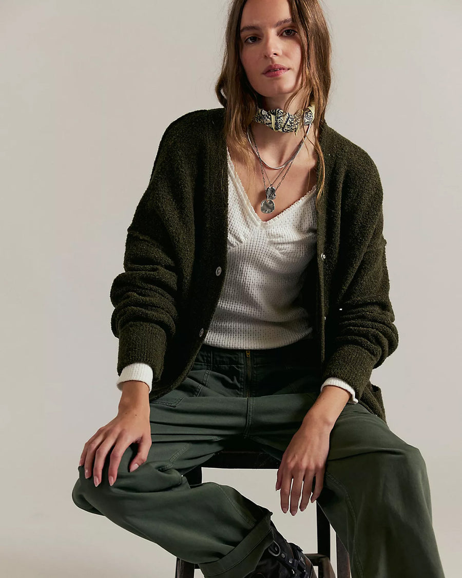 model wearing oversized green textured cardigan