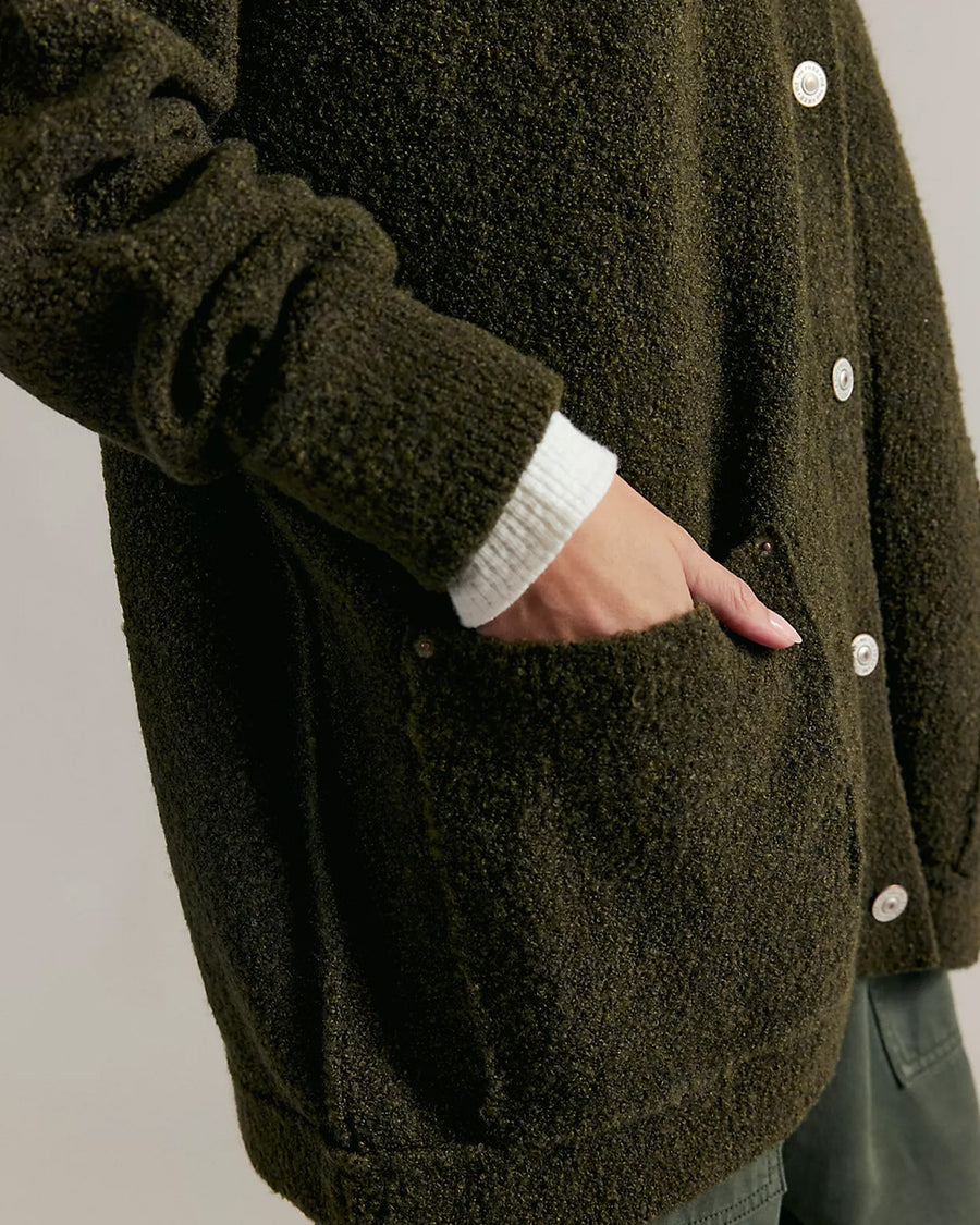 up close of model wearing oversized green textured cardigan
