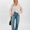 model wearing baby pink cardigan with extended placket, patch pockets and large button front