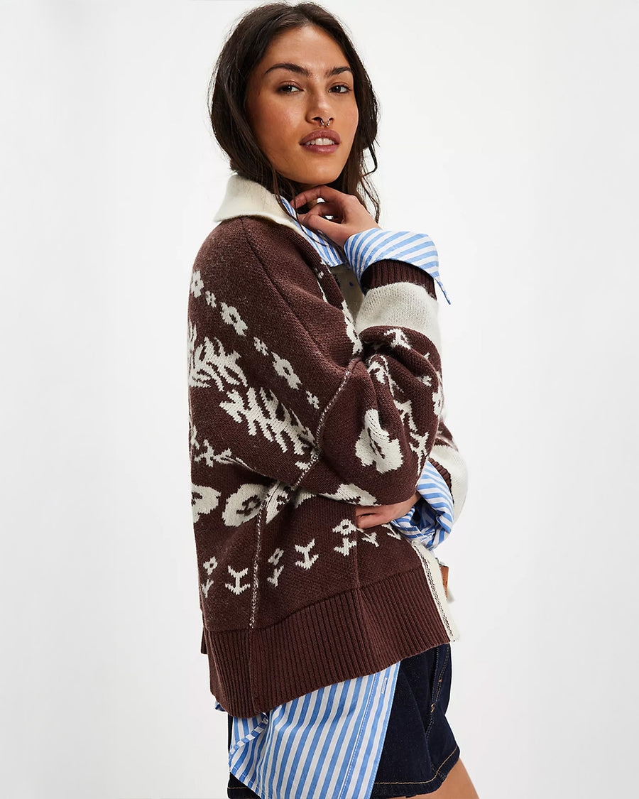 side view of brown and cream floral cardigan with cream trim