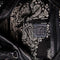 black and white paisley interior of black leather purse with several zippered pockets, double handles and crossbody strap