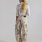 back view of model wearing tan barrel jeans with all over painted banana print