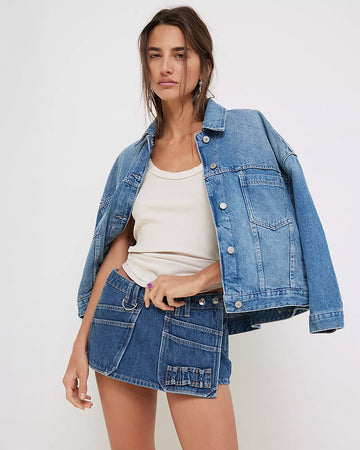 model wearing light blue cropped denim jacket with front patch pockets
