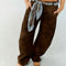 model wearing dark brown vegan suede pants