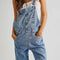 model wearing powder blue denim relaxed fit overalls