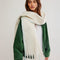 model wearing thick subtle blue and white oversized scarf with white fringe