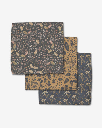 set of three dishcloths: grey with autumn colored leaves, brown with acorns and feathers, and slate whimsy floral print