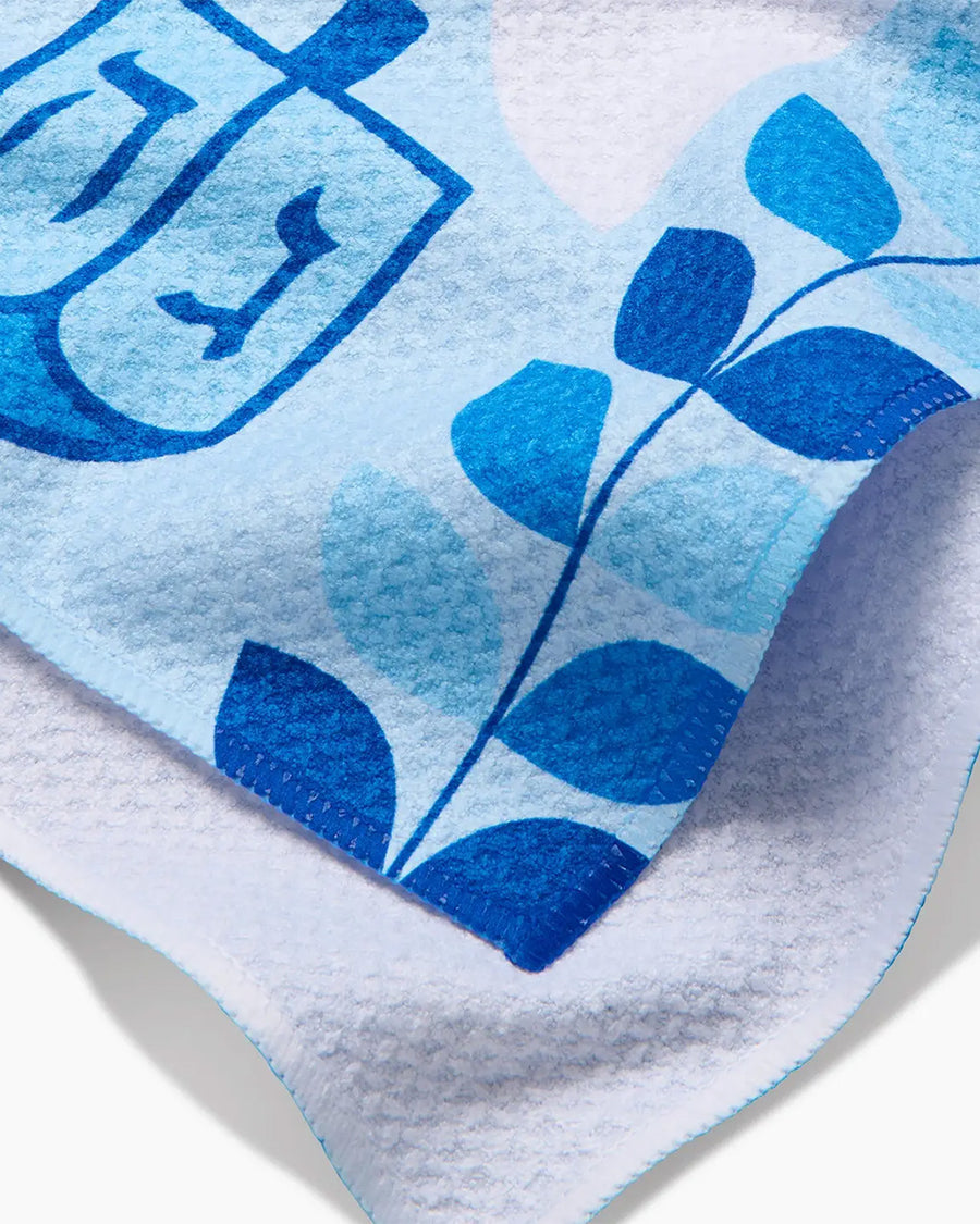 up close of blue and white Hanukkah tea towel