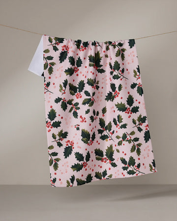 pink tea towel with holly print