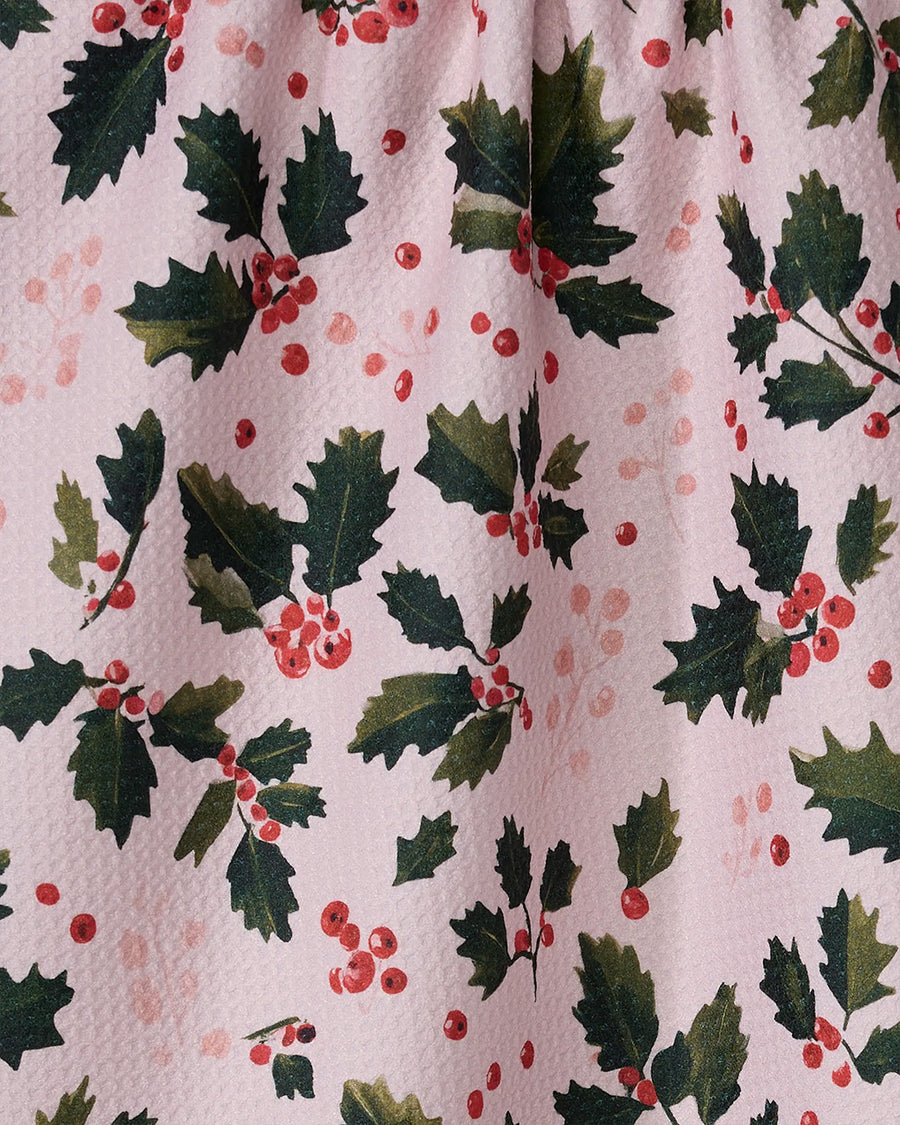 up close of pink tea towel with holly print