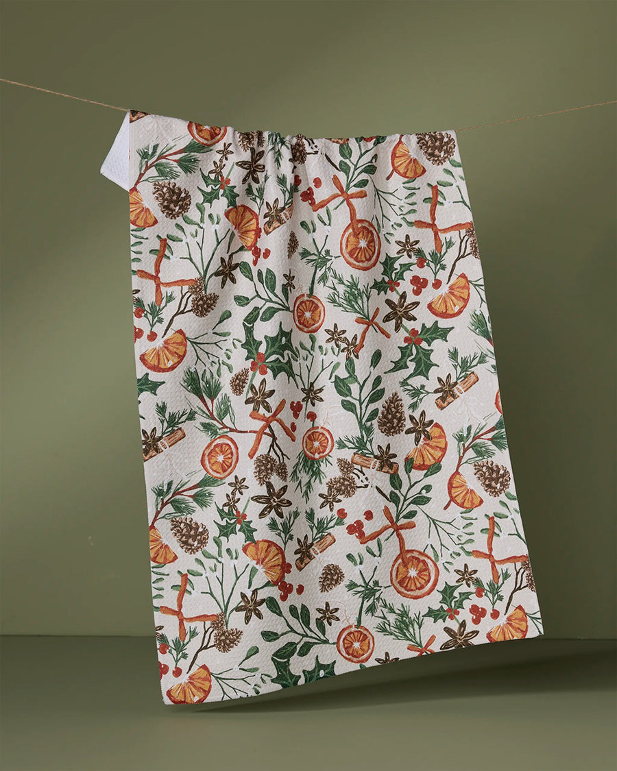 white tea towel with dried orange, cinnamon, and cranberry print