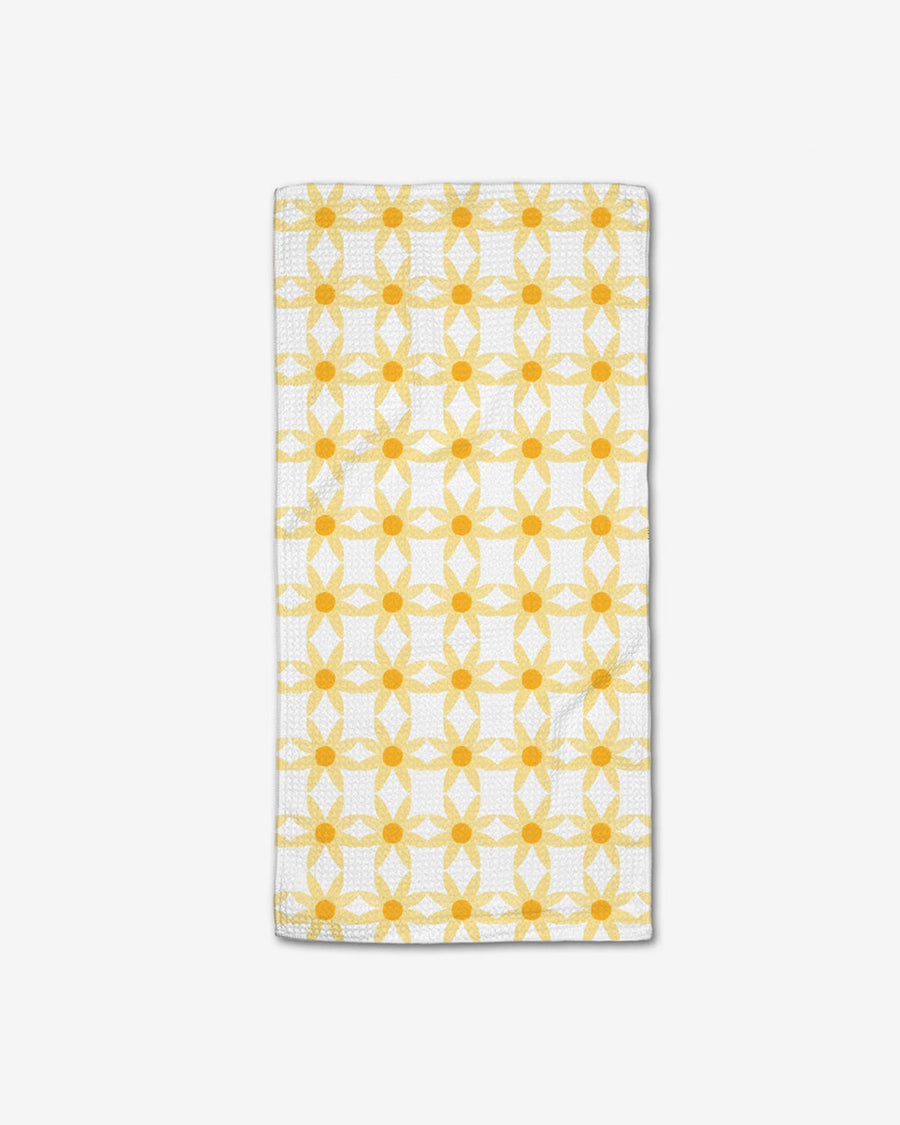 white bar towel with yellow repeating daisies print
