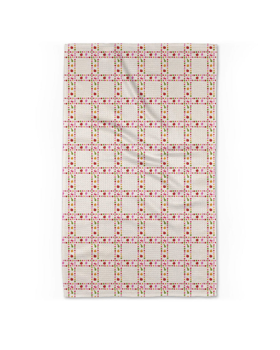 cream plaid tea towel with dainty fruit print inside the plaid