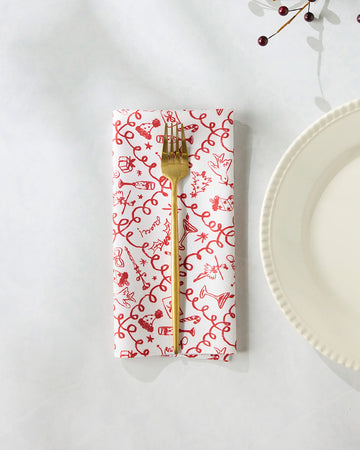 set of 6 white napkins with red holiday doodle print with a gold fork on it