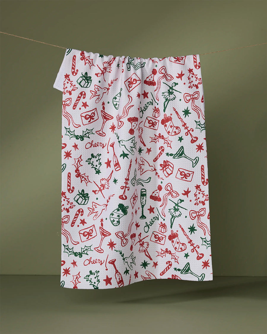 white tea towel with red and green holiday doodle print