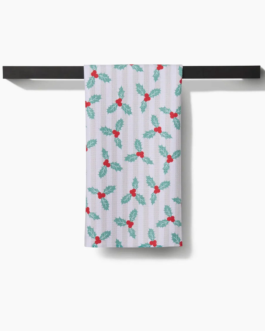 white and tan vertical stripe with mistletoe print on a towel rack