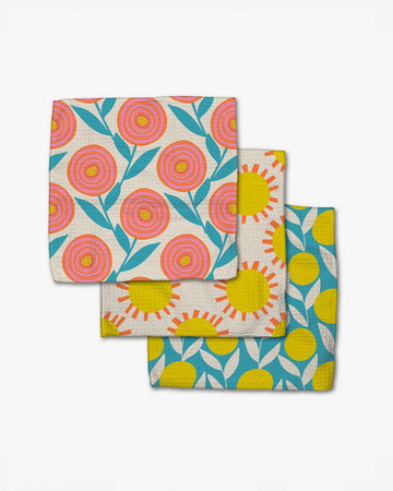set of three dish cloths: pink flower, sun, and lemon print