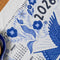 up close of white tea towel with blue sparrow birds and 2026 'calendar' by month