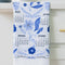 folded white tea towel with blue sparrow birds and 2026 'calendar' by month