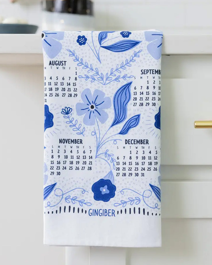 folded white tea towel with blue sparrow birds and 2026 'calendar' by month