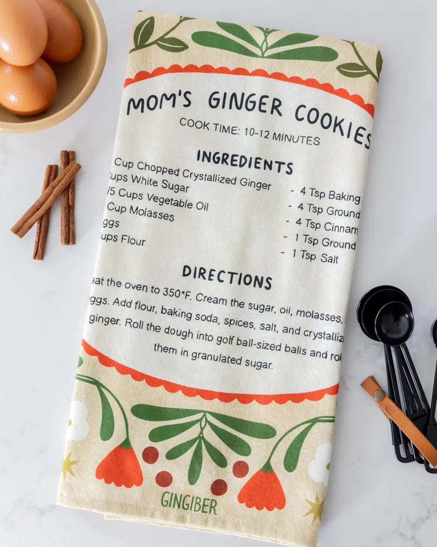 folded cream tea towel with mom's ginger cookies recipe and surrounded by cardinals and floral print