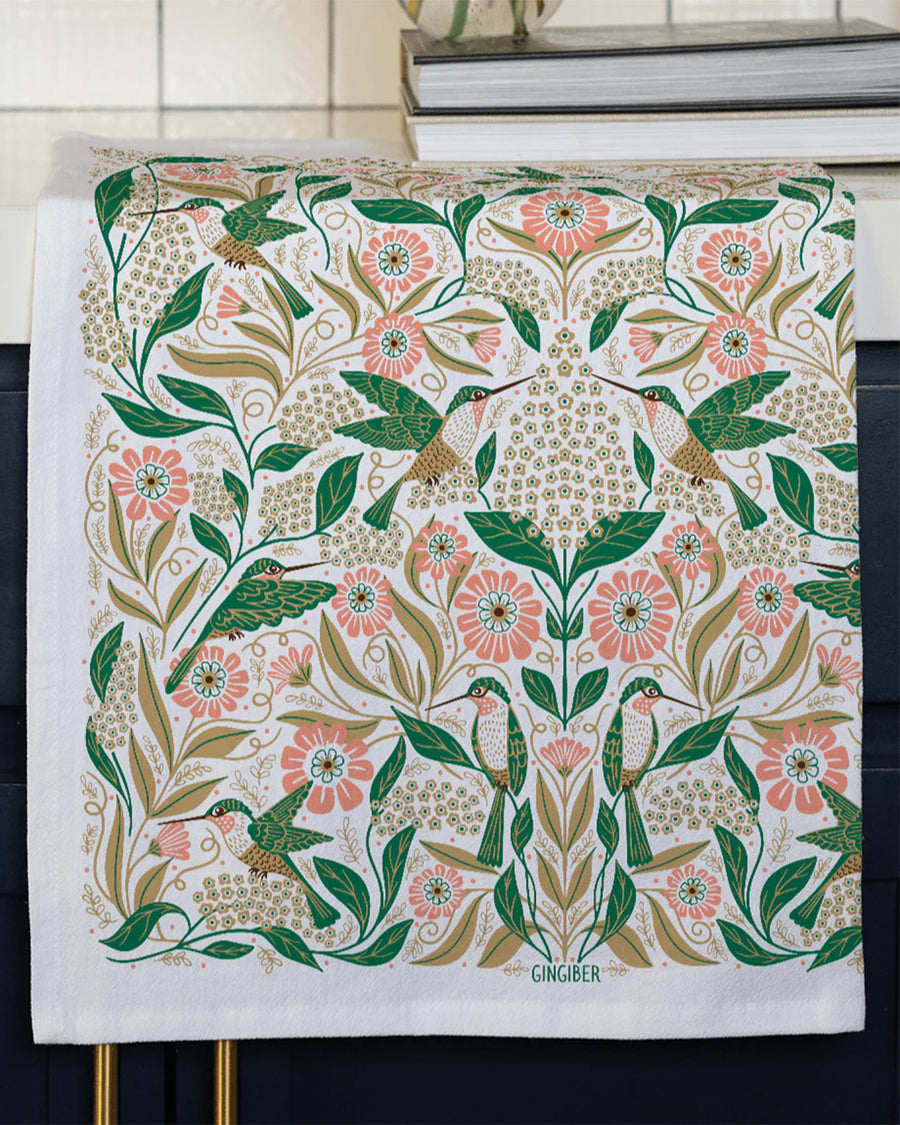 hummingbird and floral abstract tea towel hanging on a cabinet