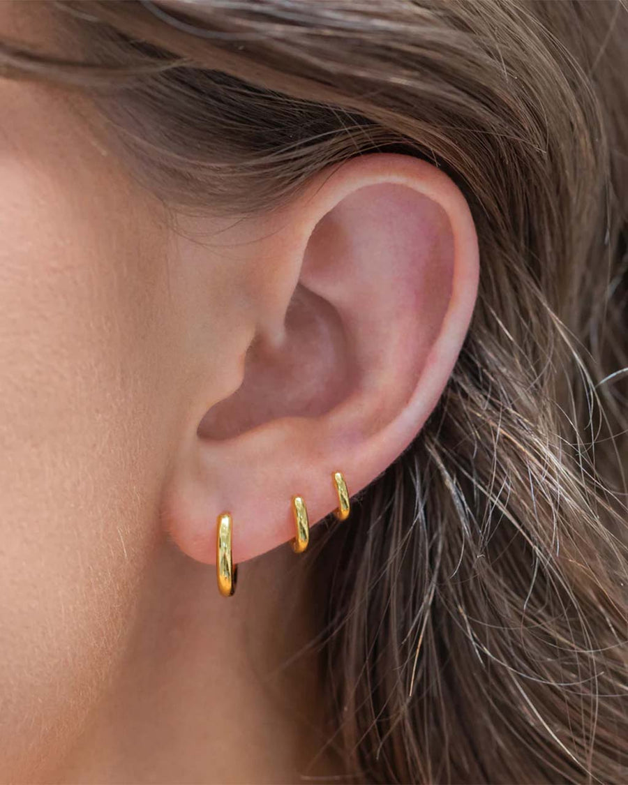 model wearing set of three gold hoop earring set