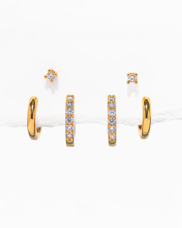 three pairs of gold essential earrings: gold hoops, crystal hoops and crystal studs
