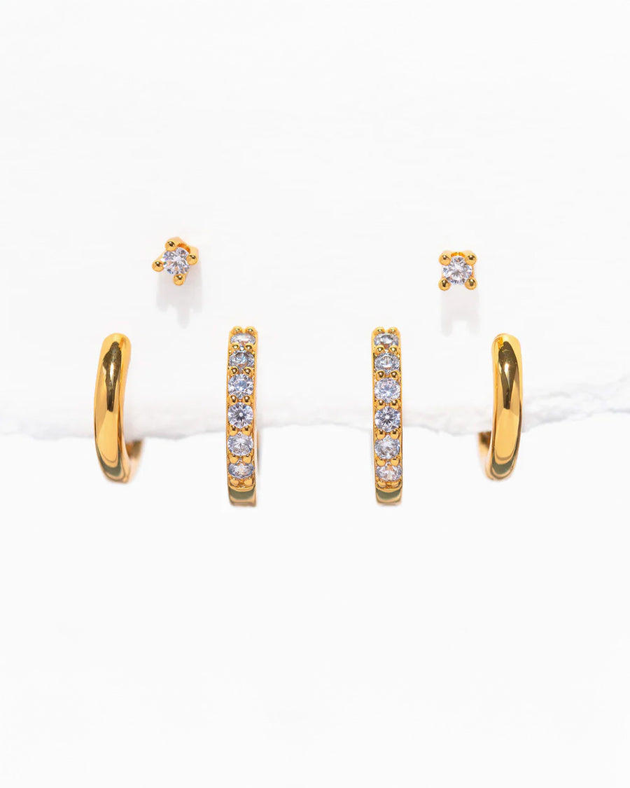 three pairs of gold essential earrings: gold hoops, crystal hoops and crystal studs