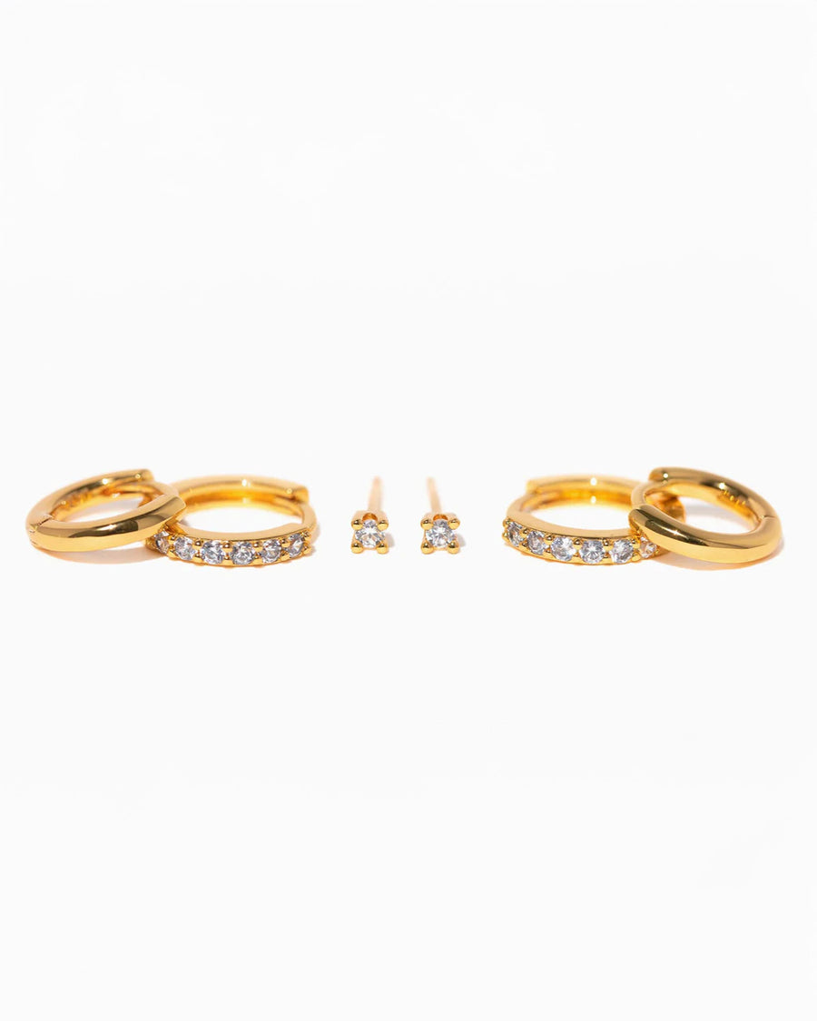 top view of three pairs of gold essential earrings: gold hoops, crystal hoops and crystal studs